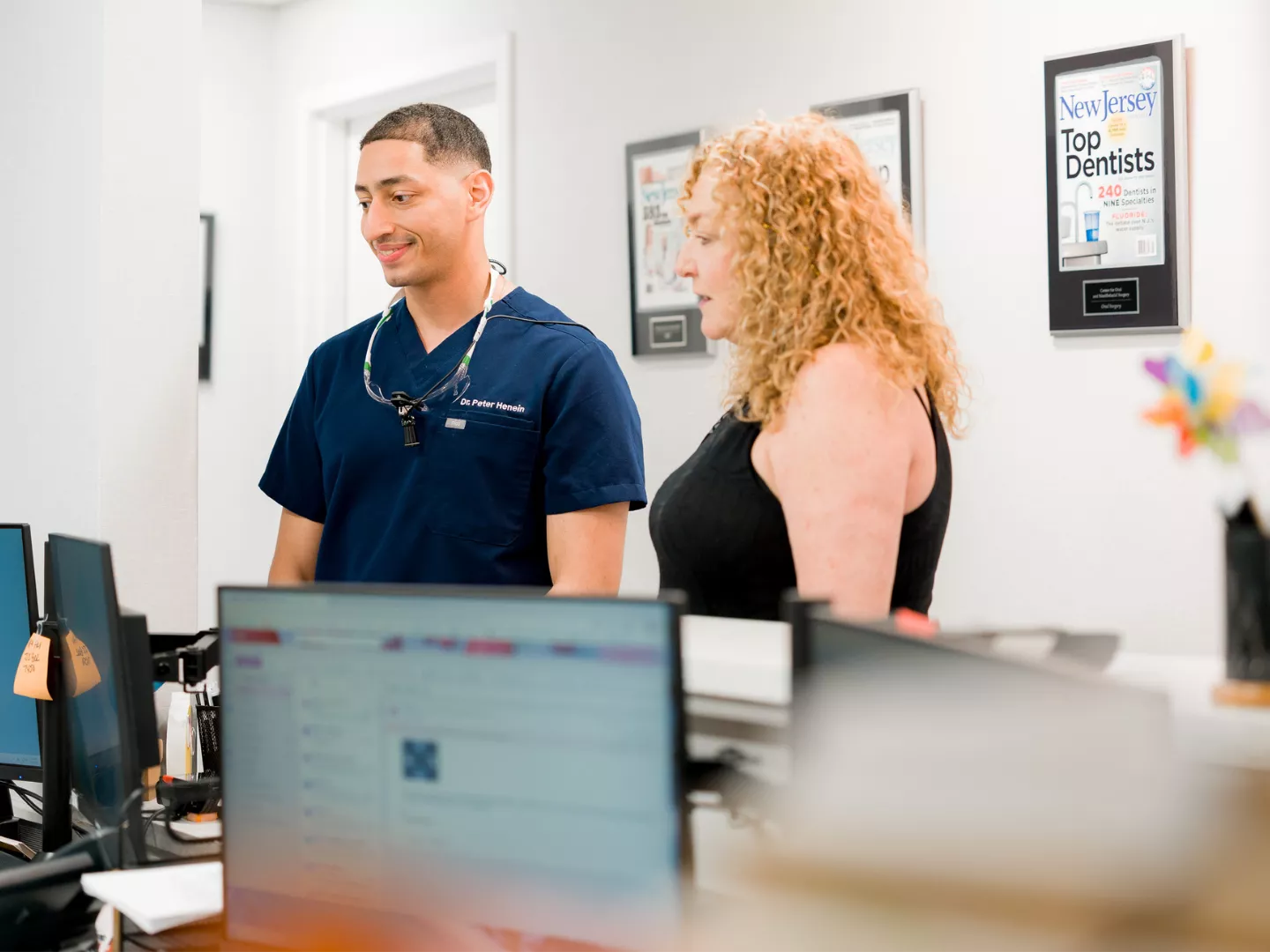 Dr. Henein stands with a patient at reception.